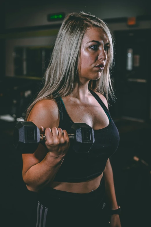 a woman working out with dumbs in a gym, a colorized photo, by Robbie Trevino, pexels contest winner, headshot photo, thicc build, ashe, bells