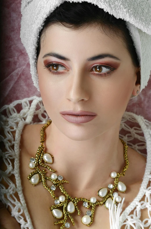 a woman with a white towel on her head, inspired by Marie-Gabrielle Capet, cg society contest winner, renaissance, gold eyeshadow, necklace on display, with sparkling hazel eyes, dark sienna and white