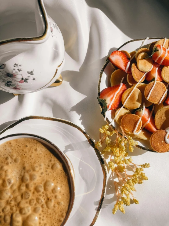 a bowl of strawberries next to a plate of cookies and a cup of coffee, by Julia Pishtar, trending on unsplash, dau-al-set, white and orange breastplate, pancakes, golden details!, medium close-up shot