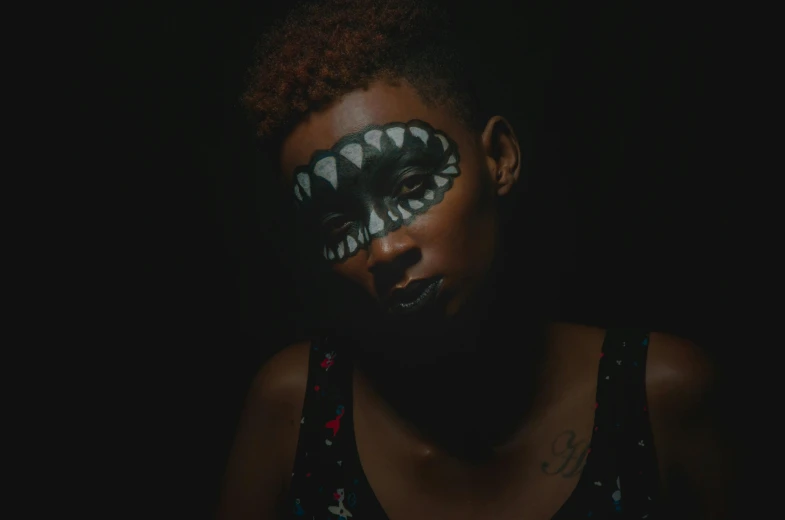 a woman with her face painted like a shark, inspired by Taro Yamamoto, pexels contest winner, afrofuturism, ( ( dark skin ) ), ashteroth, portrait of a vampire, out in the dark