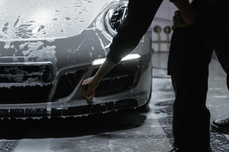 a man washing a car in a garage, by An Gyeon, pexels contest winner, porsche, 8k ultra detail, glossy white, front lit