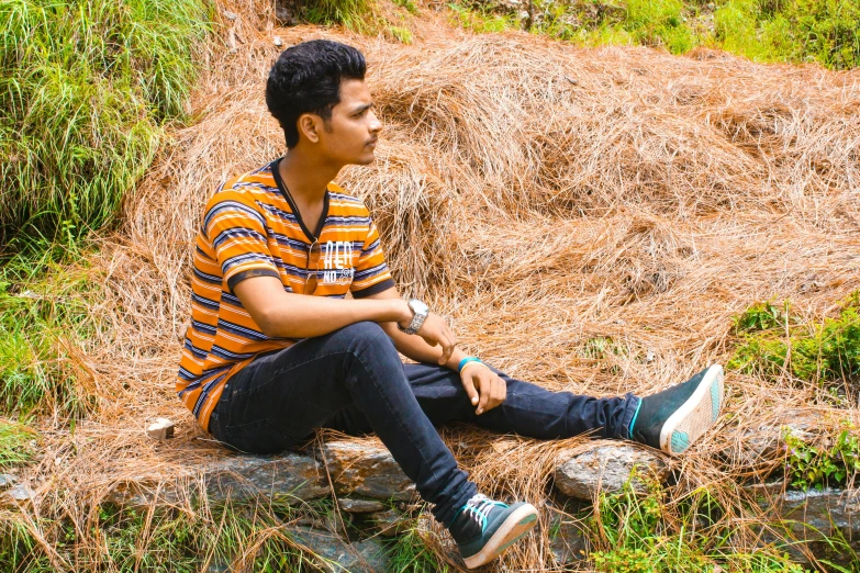 a young man sitting on top of a pile of hay, pexels contest winner, assamese aesthetic, avatar image, outdoor photo