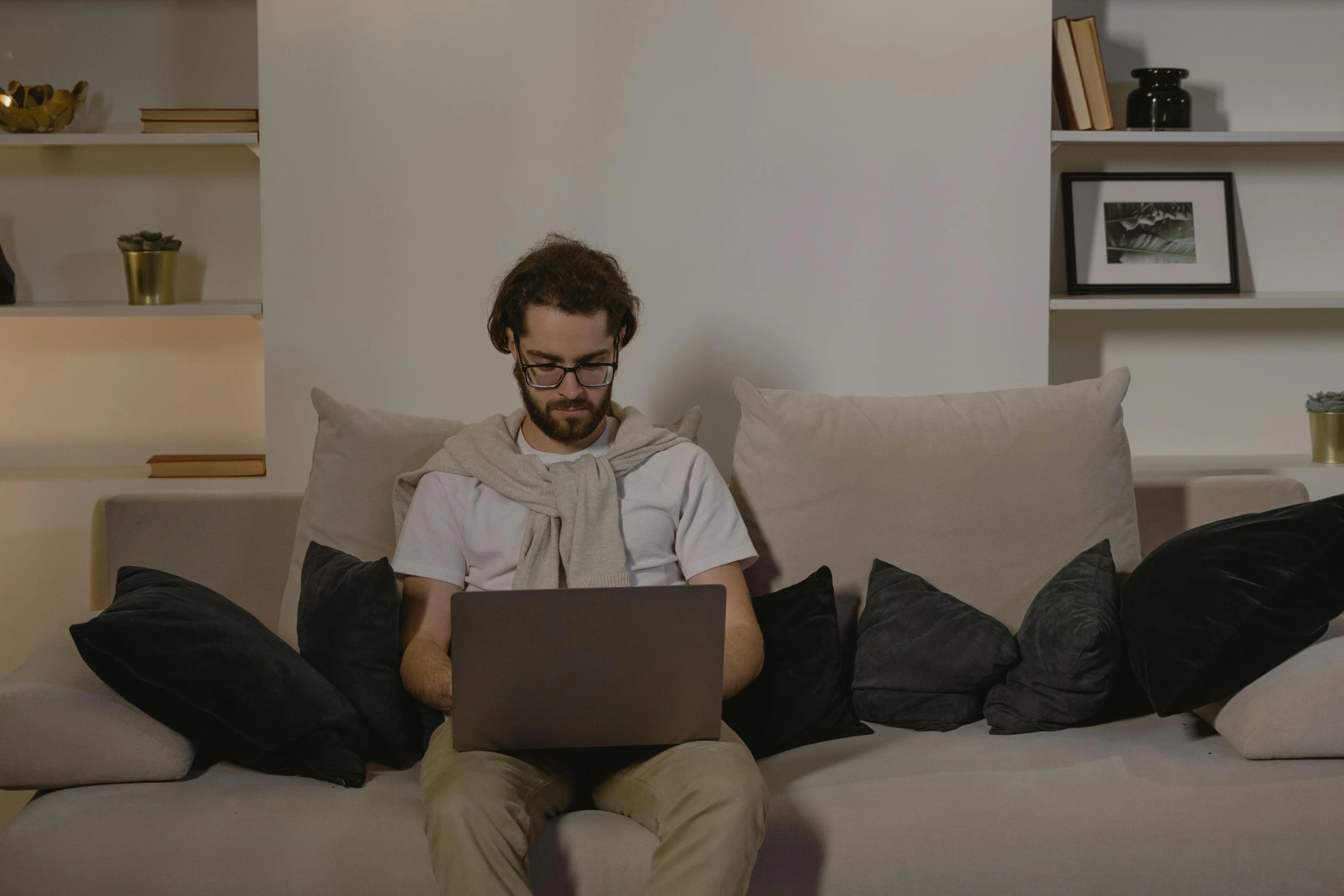 a man sitting on a couch using a laptop, trending on pexels, renaissance, asmongold, student, low fi, engineer