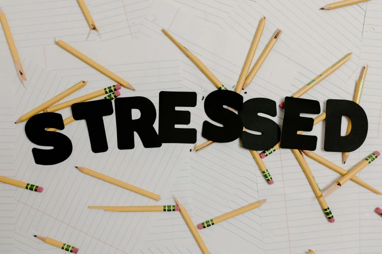 the word stressed surrounded by pencils and erases, trending on pexels, relaxed posture, netflix trese, compression, striped