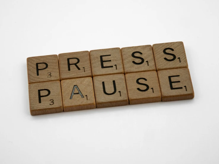 a wooden block with the word press pause written on it, a cartoon, by Lynn Pauley, unsplash, private press, victorian newspaper article, on grey background, panels, its hour come round at last