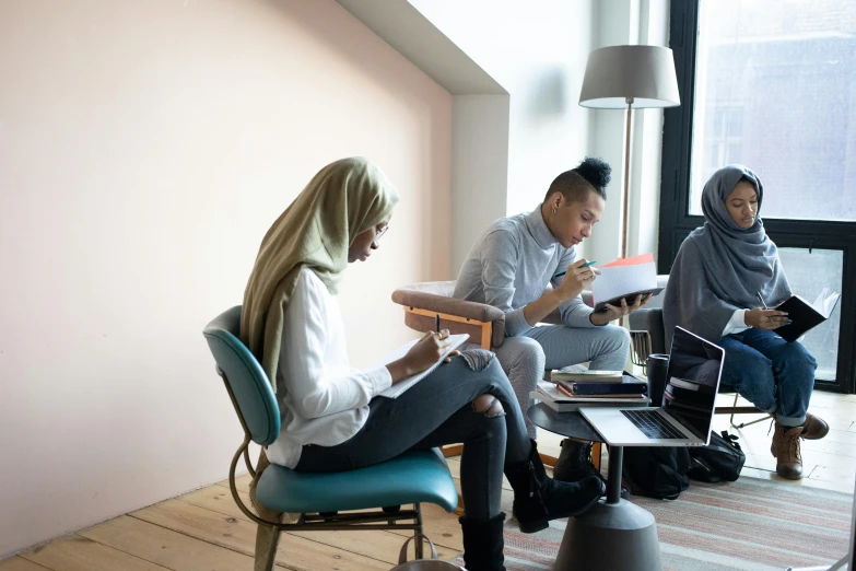 a group of people sitting in a room with laptops, trending on unsplash, hurufiyya, behance lemanoosh, muslim, workers, alana fletcher