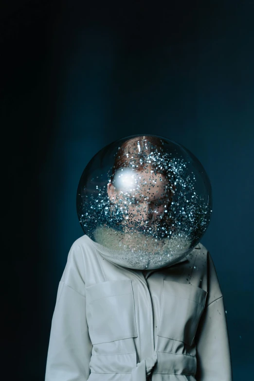 a close up of a person wearing a space suit, an album cover, by Adam Marczyński, spheres, boke, aleksandra waliszewska, freezing