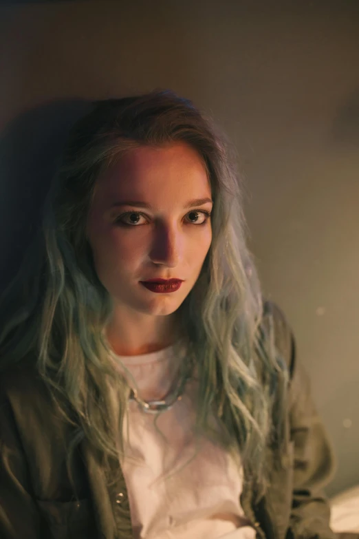 a woman sitting in front of a laptop computer, a portrait, inspired by Elsa Bleda, unsplash, dyed hair, low - lighting, 1 6 years old, headshot