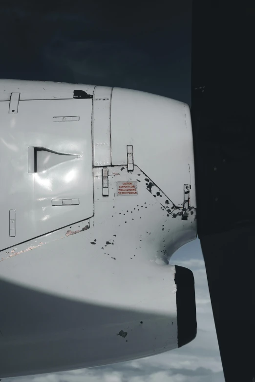 a large jetliner sitting on top of an airport tarmac, a stipple, by Daniel Taylor, unsplash, auto-destructive art, machine parts embedded into face, looking down from above, white with black spots, crashed