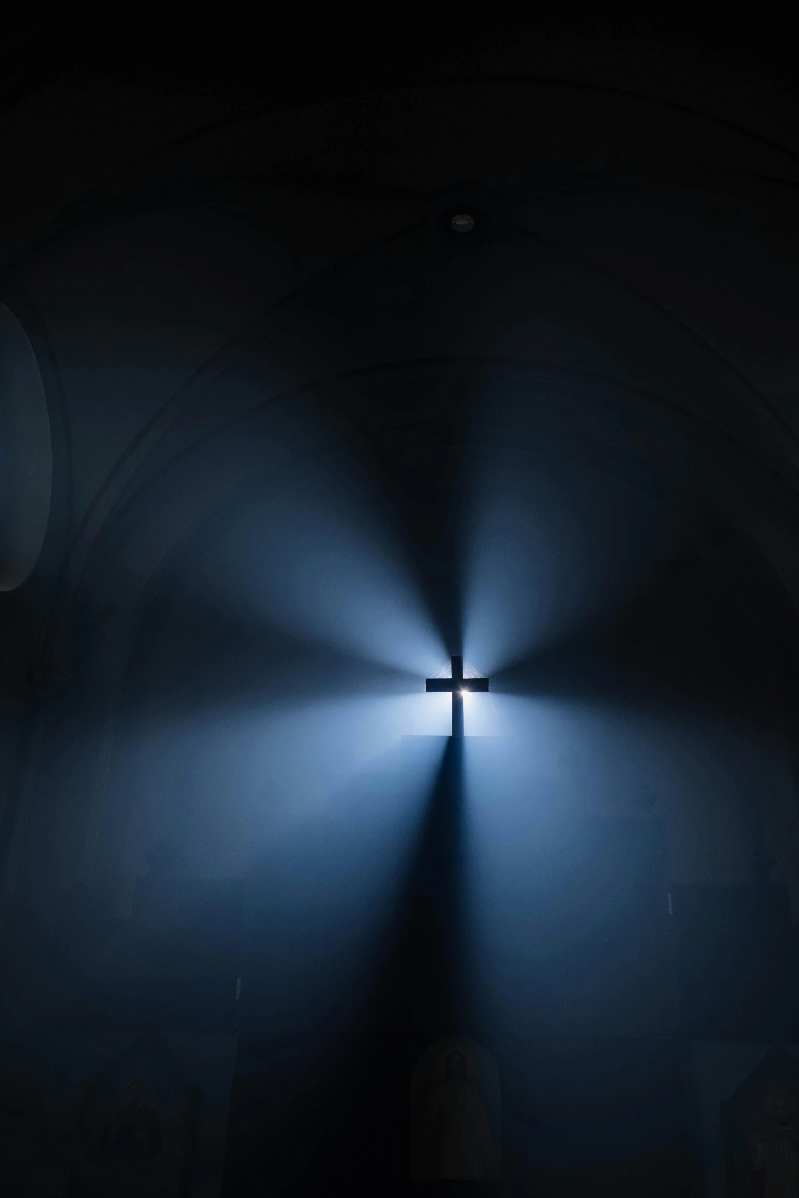 a cross in the middle of a dark room, light and space, lightshow, soft blue light, 2019 trending photo, searchlight