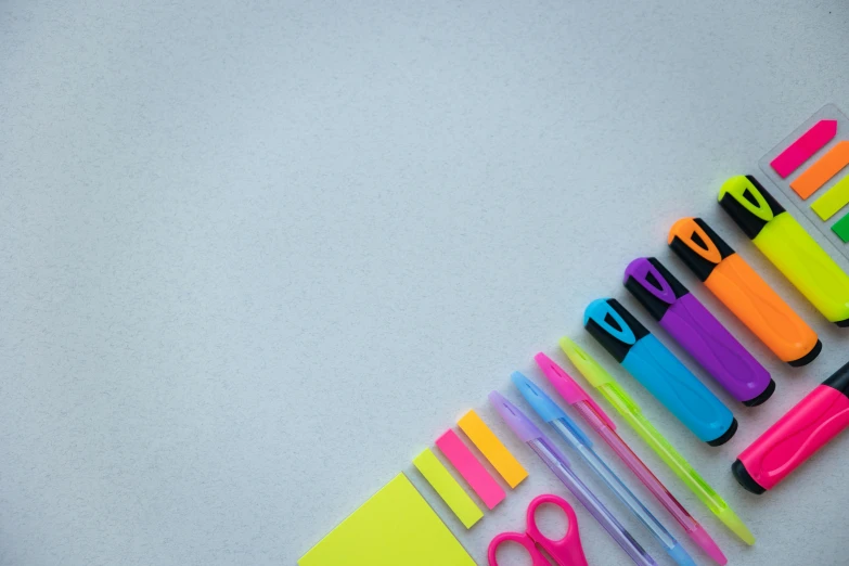 a group of office supplies sitting on top of a table, a picture, ((neon colors)), scissors, thumbnail, educational supplies