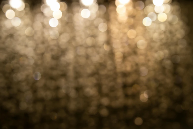 a close up of a chandelier with lights in the background, inspired by Elsa Bleda, unsplash, golden fabric background, ethereal lighting - h 640, boke, brown