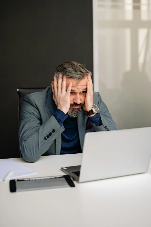 a man sitting at a desk in front of a laptop computer, such disappointment, gray men, thumbnail, 8