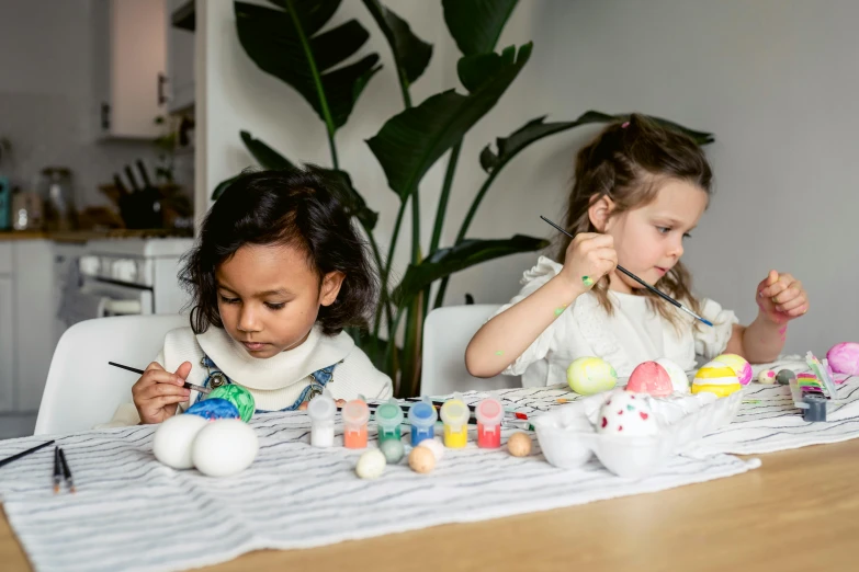 two little girls painting easter eggs on a table, inspired by Louis Le Nain, pexels contest winner, cafe for felted animals, art set, white paint, multi colour