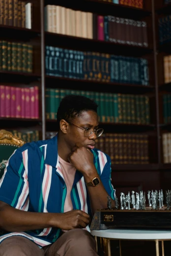a man sitting at a table playing a game of chess, an album cover, by Lily Delissa Joseph, trending on unsplash, renaissance, man with glasses, kehinde wiley, movie still of a tired, in a library