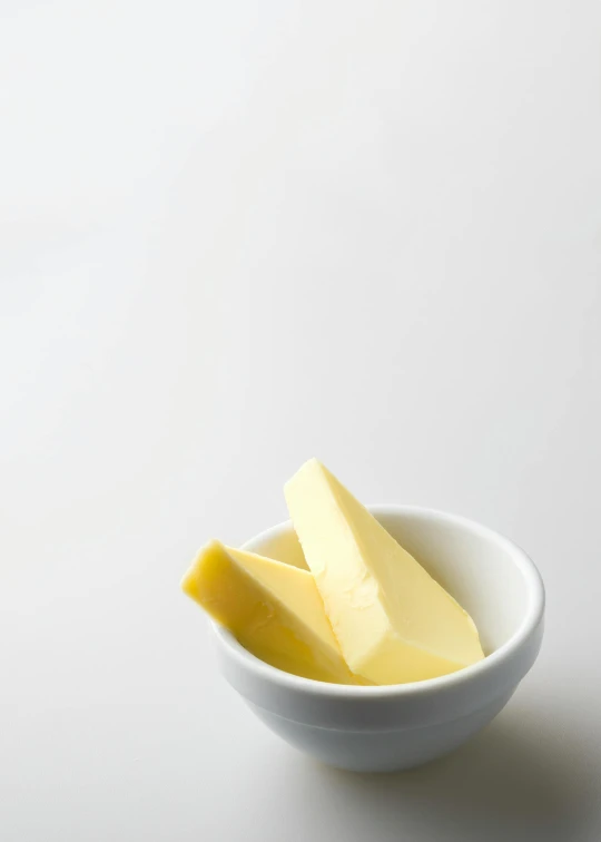 a white bowl filled with butter sitting on top of a table, crisp image, lumi, product photo, vanilla