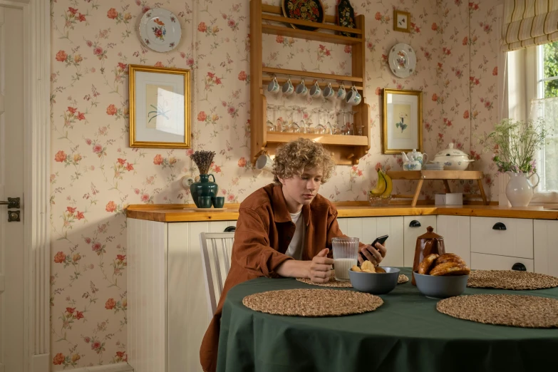 a woman sitting at a table with a bowl of food, inspired by Lasar Segall, hyperrealism, cozy wallpaper, teenage boy, production still, cottagecore