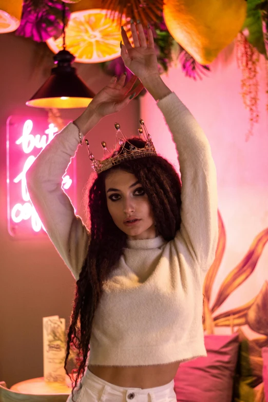 a woman holding a bunch of flowers above her head, a portrait, inspired by Elsa Bleda, trending on pexels, wearing an egyptian crown, neon lights in the background, portait of haifa wehbe, milk bar magazine