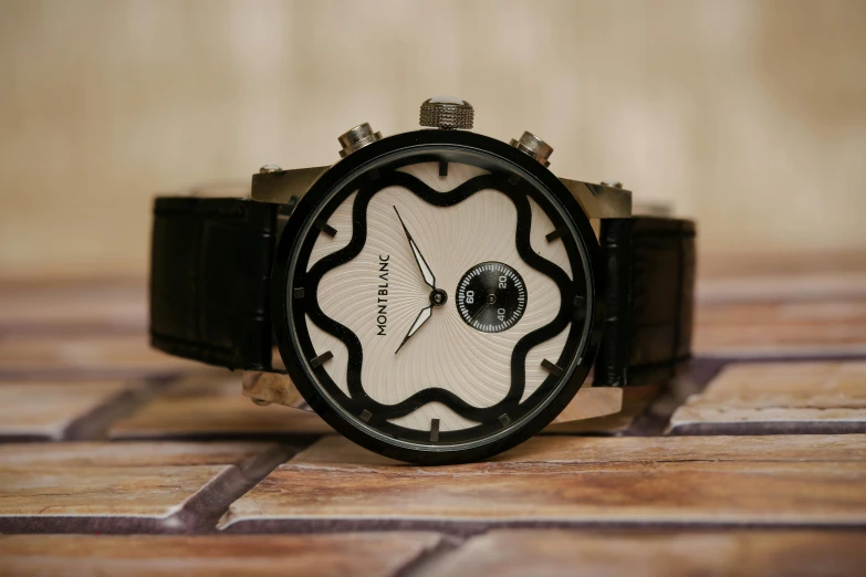 a close up of a watch on a table, inspired by Johannes Martini, art nouveau, white and black, it's morbin time, medium wide front shot, shot on sony a 7