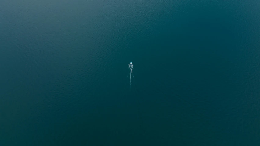a small boat in the middle of a large body of water, by Sebastian Spreng, unsplash contest winner, minimalism, no people 4k, helicopter view, floating ghost, single figure
