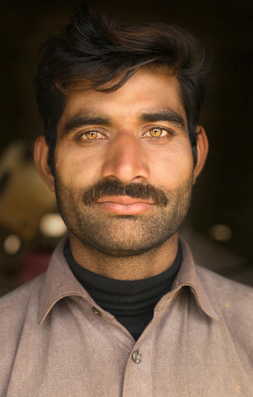 a close up of a person wearing a shirt, a character portrait, inspired by Steve McCurry, pexels contest winner, an afghan male type, with trimmed mustache, high resolution photo, frontal portrait of a young