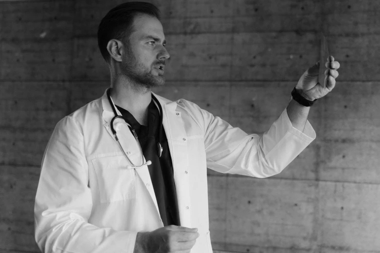 a black and white photo of a man in a lab coat, by Adam Marczyński, pexels, angry and pointing, presentation, male physician, jesse pinkman