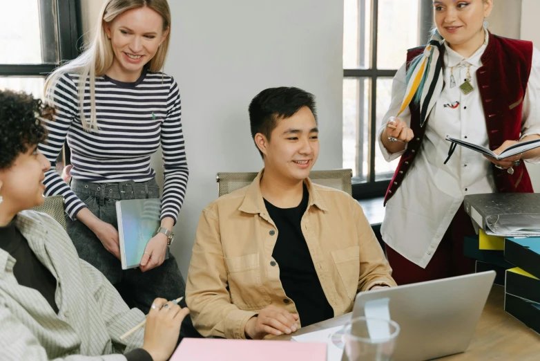 a group of people sitting around a table with laptops, a cartoon, trending on pexels, office clothes, lachlan bailey, awarding winning, asian male