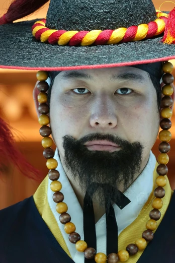 a close up of a person wearing a hat, inspired by Kim Hong-do, renaissance, goatee, korean traditional palace, wearing imperial gear, stubble on his face