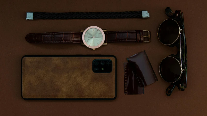 a watch, sunglasses, wallet, and other items laid out on a table, a still life, trending on pexels, assemblage, smartphone photo, brown colours, made in bronze, detailed product image