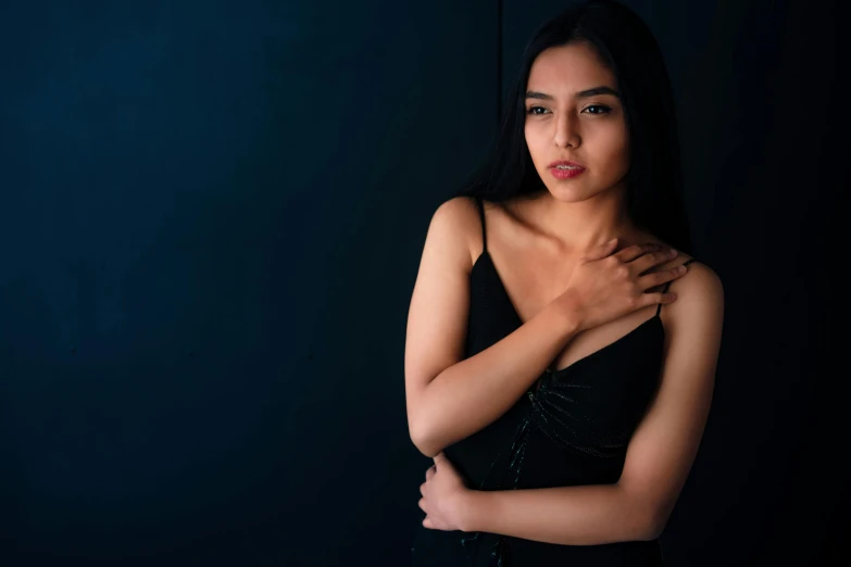 a woman in a black dress posing for a picture, pexels contest winner, hurufiyya, side boob, 1 6 years old, provocative indian, olive skin