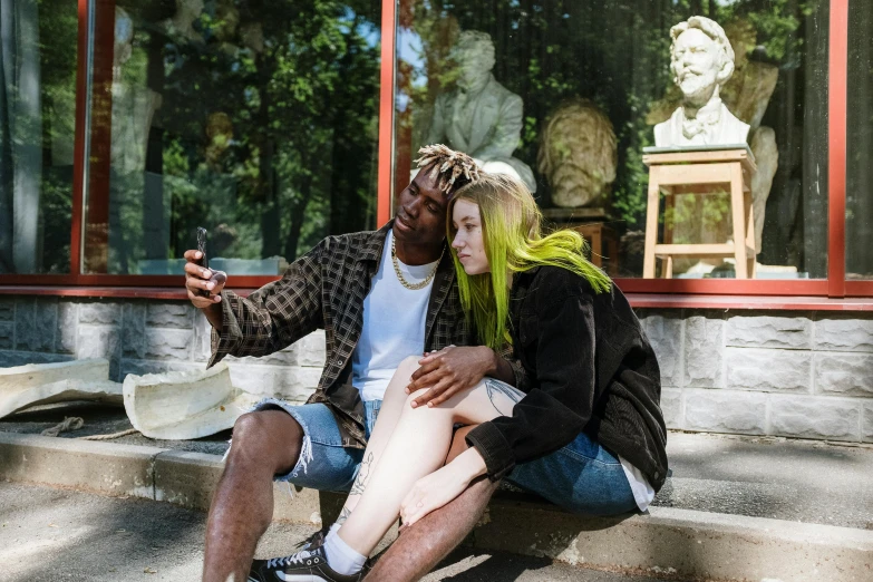 a man and woman sitting on the steps of a building, a photo, trending on pexels, realism, lil uzi vert, at a museum, green and brown clothes, smartphone photo