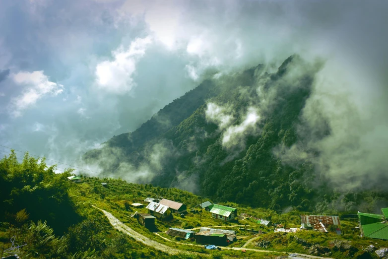 a group of houses sitting on top of a lush green hillside, by Muggur, pexels contest winner, in a cloud, avatar image, hut, high angle view