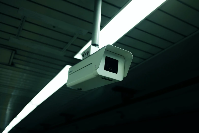 a camera mounted to the ceiling of a building, inspired by Elsa Bleda, unsplash, conceptual art, square, dash cam, looking threatening, gallery lighting