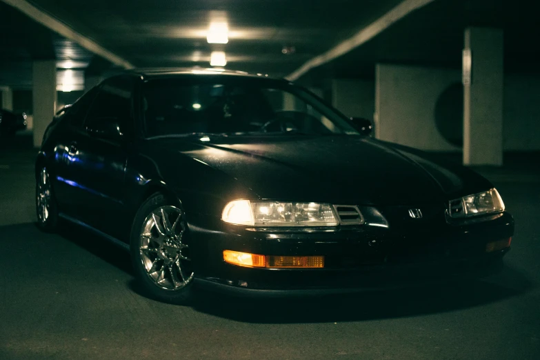 a black car parked in a parking garage, inspired by Hiroshi Honda, unsplash, photorealism, honda nsx, portrait soft low light, 15081959 21121991 01012000 4k, taken in the early 1990s