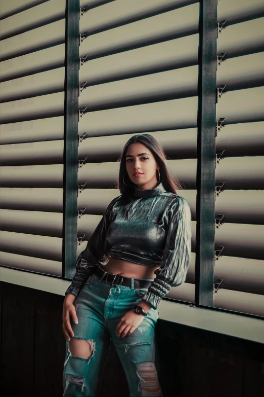 a woman standing in front of a window, inspired by Elsa Bleda, trending on pexels, hyperrealism, leather top, metal shutter, madison beer, hyper realistic background