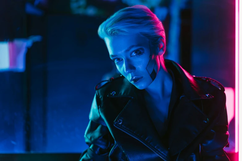 a woman standing in front of a neon light, cyberpunk art, inspired by Elsa Bleda, unsplash contest winner, bauhaus, amber heard as captain america, cyberpunk dyed haircut, blue color grading, sydney sweeney