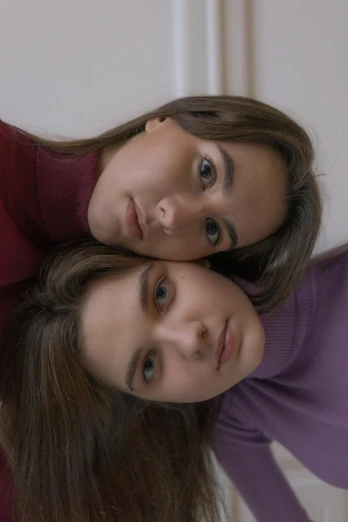 a couple of women standing next to each other, a colorized photo, trending on pexels, photorealism, brown hair and large eyes, lying down, gen z, low quality video