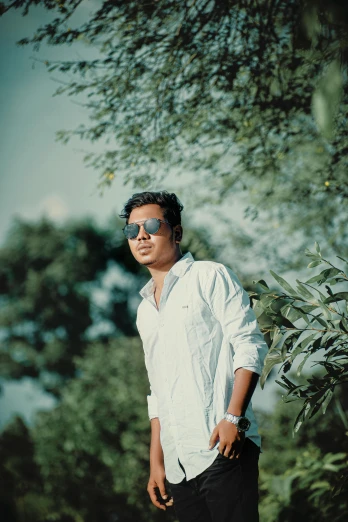 a man in a white shirt and black pants, inspired by Bikash Bhattacharjee, unsplash, facebook profile picture, greenery, vintage color, around 1 9 years old