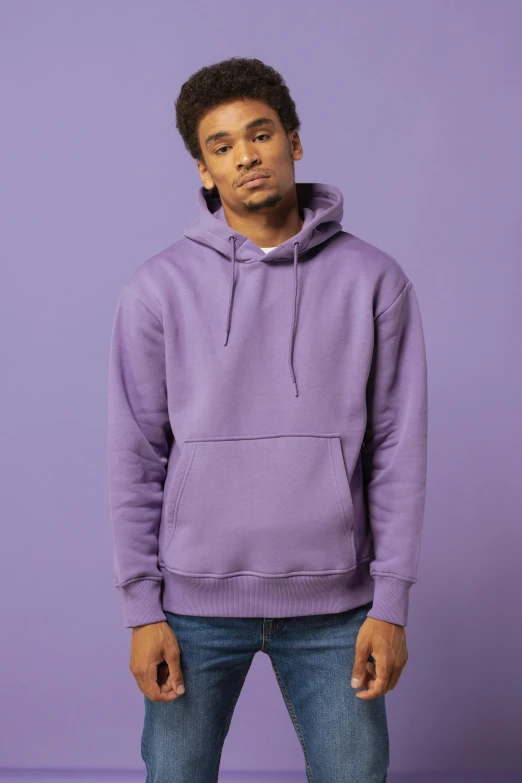 a man in a purple hoodie stands against a purple background, a picture, trending on pexels, japanese streetwear, plain background, pastel clothing, thumbnail