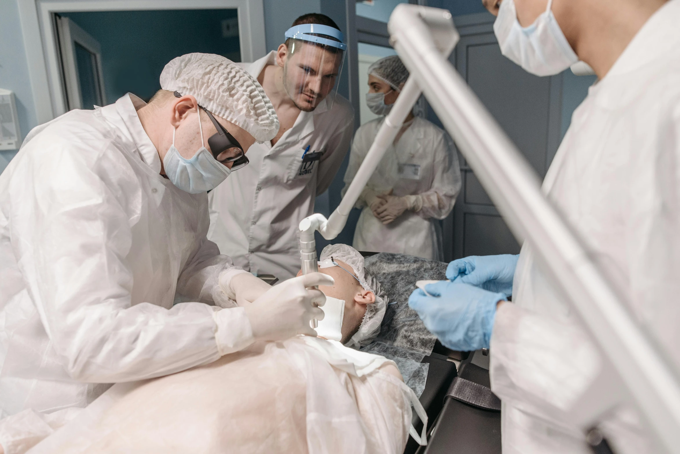 a group of doctors working on a patient, by Adam Marczyński, pexels contest winner, massurrealism, with a white complexion, surgical supplies, rectangle, thumbnail