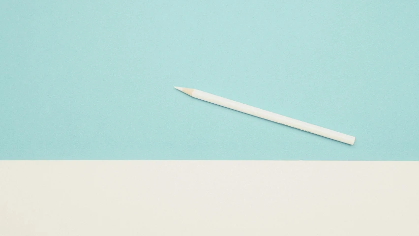 a white pencil sitting on top of a blue and white surface, inspired by Agnes Martin, unsplash, teal paper, clemens ascher, adrian tomine, spear