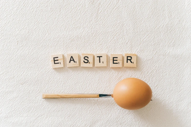 the word easter spelled with scrabbles next to an egg, by Ellen Gallagher, trending on unsplash, spoon placed, duster, an artistic pose, bomberman