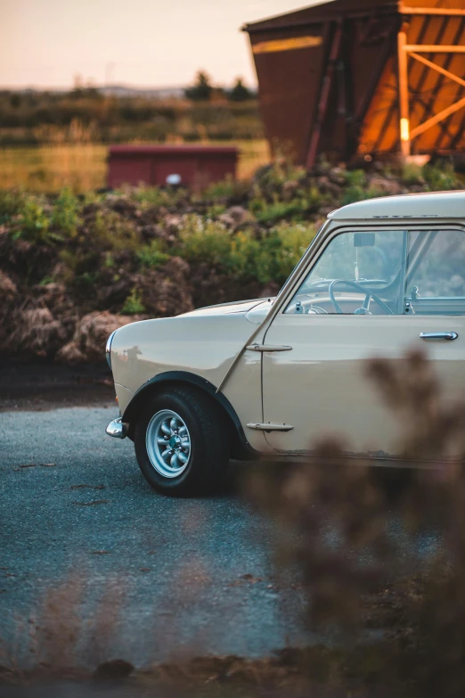 an old car parked in front of a barn, by Austin English, unsplash, renaissance, mini model, brown and cream color scheme, profile picture, late 1 9 6 0's