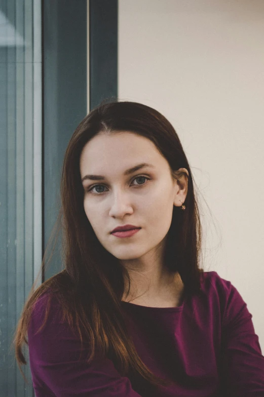 a beautiful young woman sitting in front of a window, by Adam Marczyński, pexels contest winner, halfbody headshot, russian academic, portrait sophie mudd, on a gray background