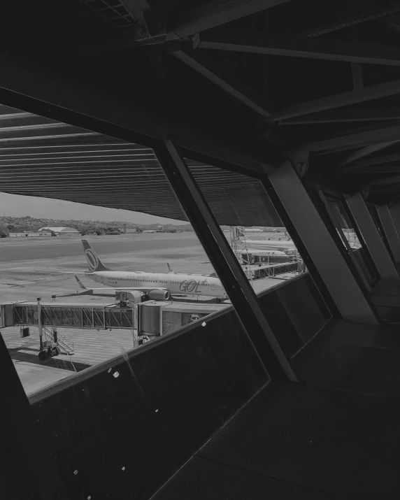 a black and white photo of an airport, pexels contest winner, brutalism, inside large window of ship, lofi vibes, space seen outside from a window, instagram post