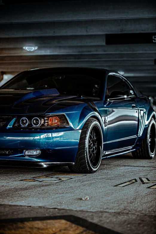 a blue mustang parked in a parking garage, a portrait, unsplash, modded, rim lights, late 2000’s, smooth hd