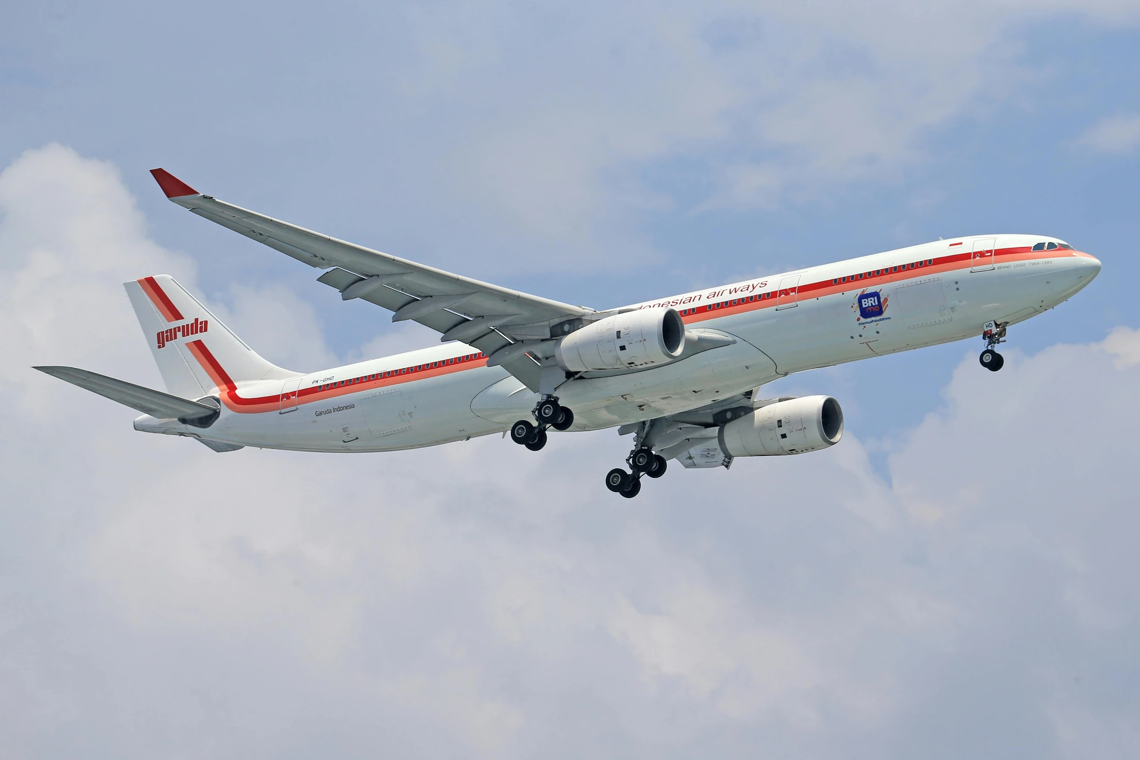 a large jetliner flying through a cloudy blue sky, by Jim Murray, flickr, hurufiyya, red and white colors, orange and white, wide neck, nobutaka ike