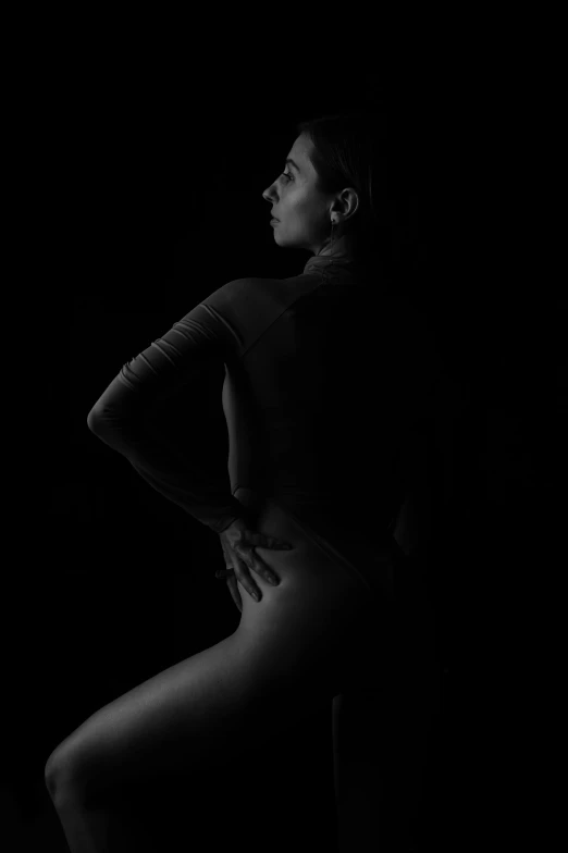 a man standing in the dark with his hands on his hips, by Clifford Ross, unsplash contest winner, figurative art, female dancer, profile image, bella poarch, woman is sitting