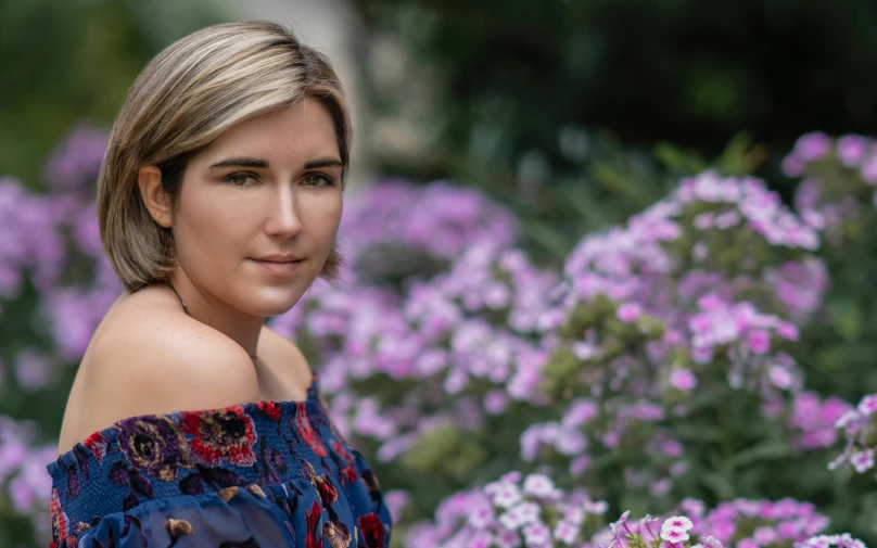 a woman standing in a field of purple flowers, a portrait, by Meredith Dillman, pexels contest winner, portrait of florence pugh, headshot portrait, standing in a botanical garden, shot on sony a 7