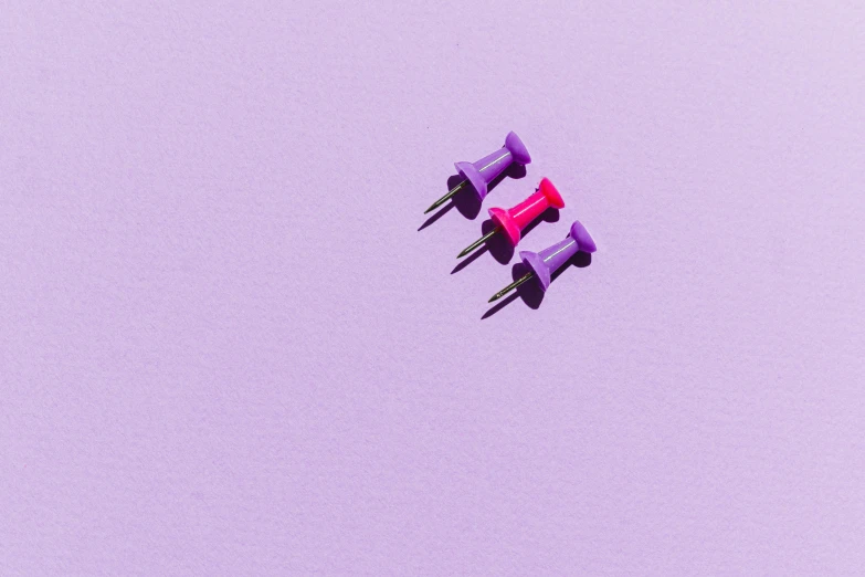 a group of purple push pins sitting on top of a purple surface, a minimalist painting, pexels, minimalism, fuchsia, paper quilling, computer wallpaper, three colors